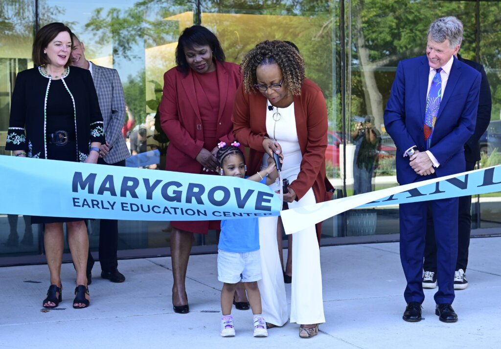 Woman and child cut ribbon at Marygrove Early Education Center grand opening celebration