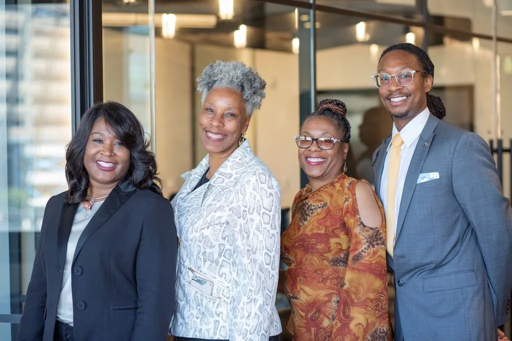 Four real estate developers from the EDI program pose together