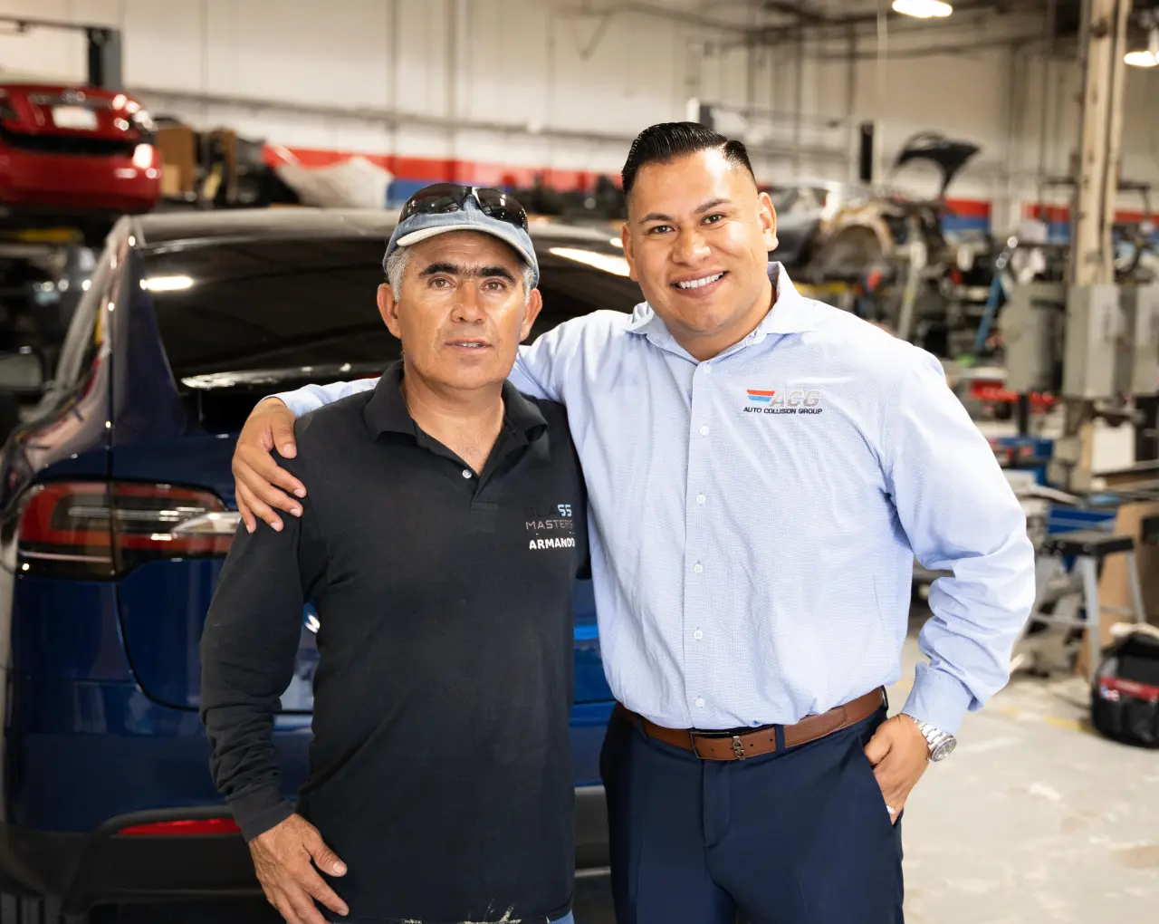Latino small business owner stands in his auto repair shop after obtaining an SBA 504 commercial real estate loan in Santa Ana California.