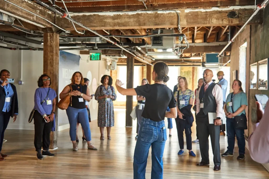 Real estate developers of color meet inside of a building under construction during an event hosted by Momentus Capital