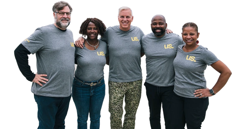 The Momentus Capital Capital Impact Partners Executive Management team gathers together at a company event, all wearing the same t-shirt and smiling (transparent background).