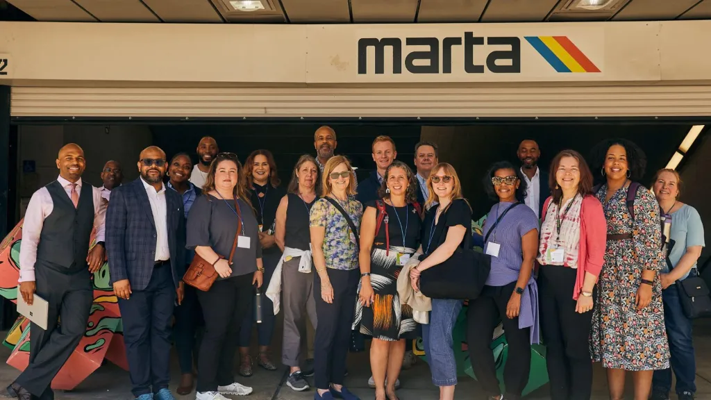 A group of professionals standing in front of a Marta station in Atlanta