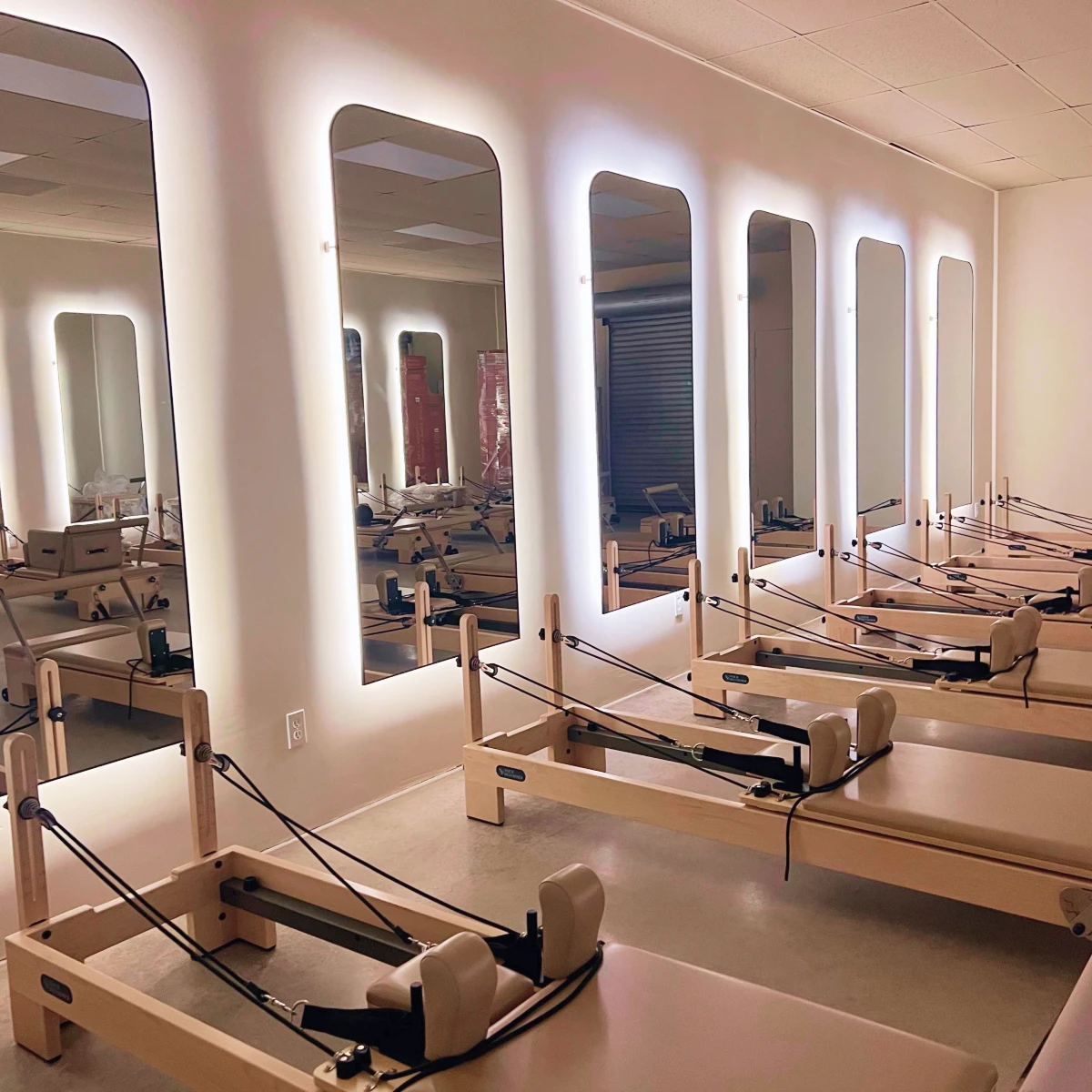 Viva Pilates Studio’s relaxing space showcasing their clean, well-maintained equipment featured in the Momentus Capital holiday gift guide to support small businesses as a Wellness & Self-Care gift.