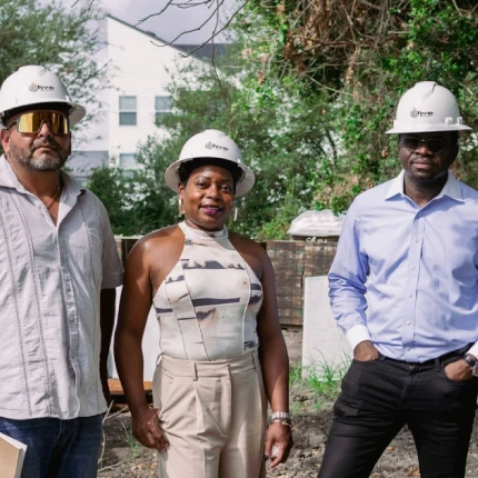 Developers and construction workers stand together at the Fairwoods at Furman groundbreaking in Houston, a future affordable housing townhome project.