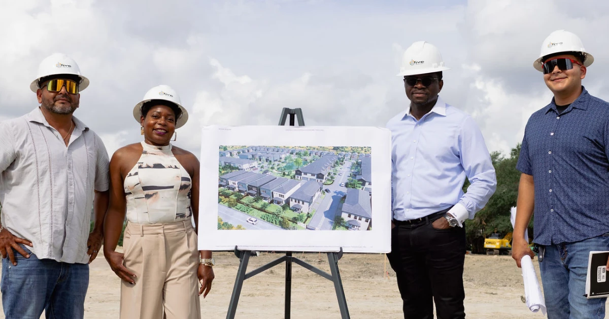 Two developers stand next to two construction workers and a site rendering at the Fairwoods at Furman groundbreaking in Houston, a future affordable housing townhome project.