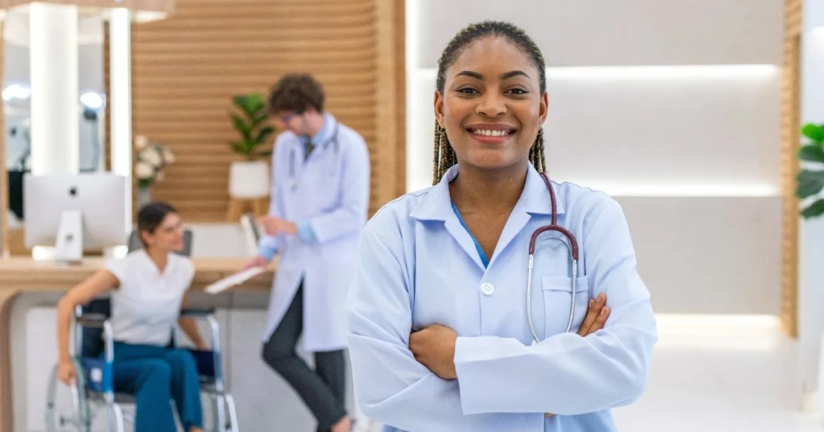 Smiling doctor in a modern health center that received the benefits of New Markets Tax Credit financing.