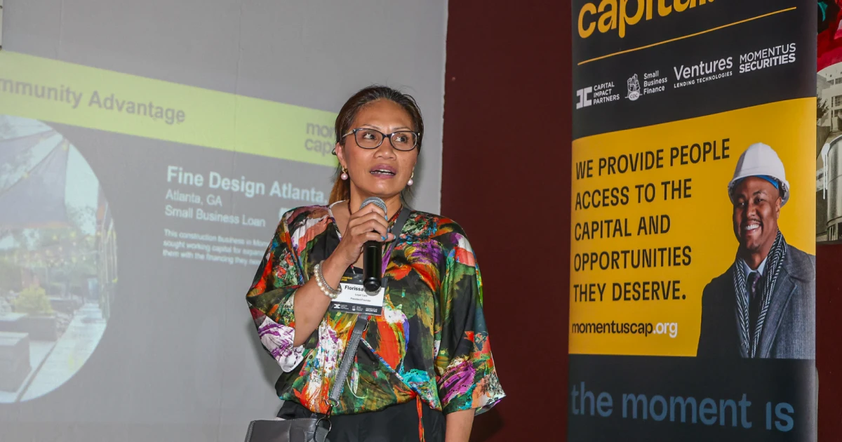 An Atlanta entrepreneur speaking on a microphone after receiving financing from Momentus Capital.