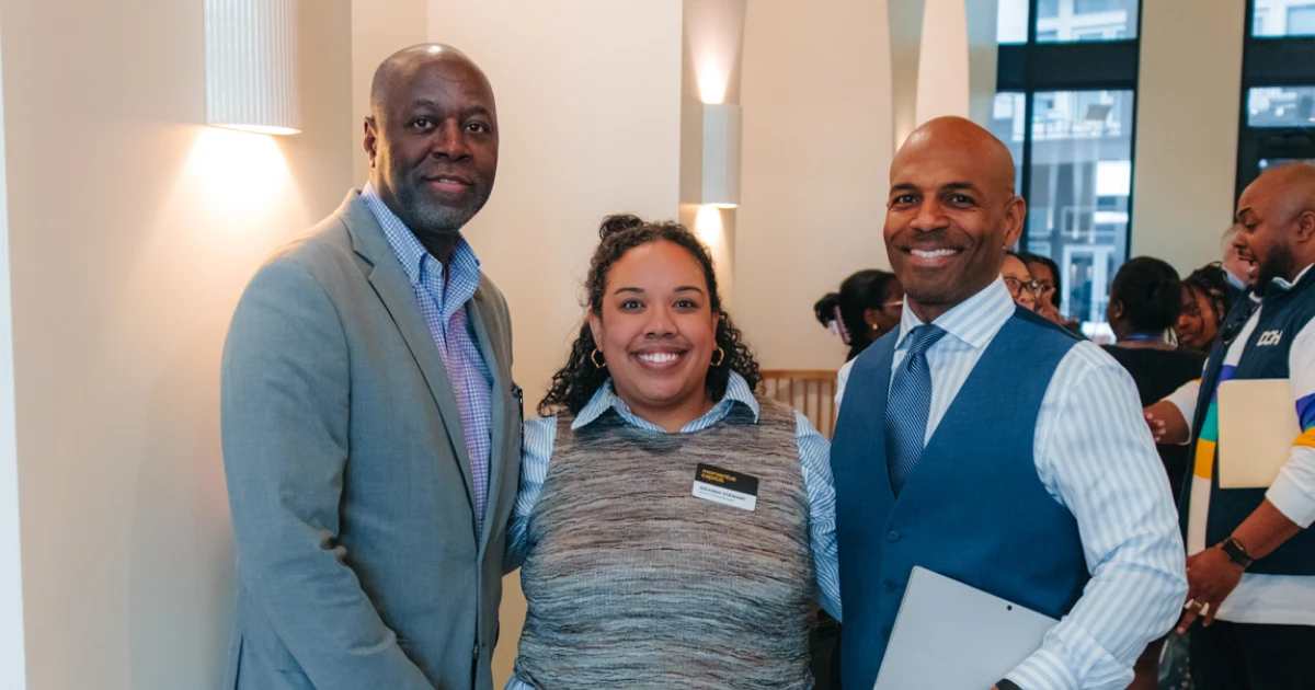 Two Atlanta real estate developers pose with a staff member from Momentus Capital.