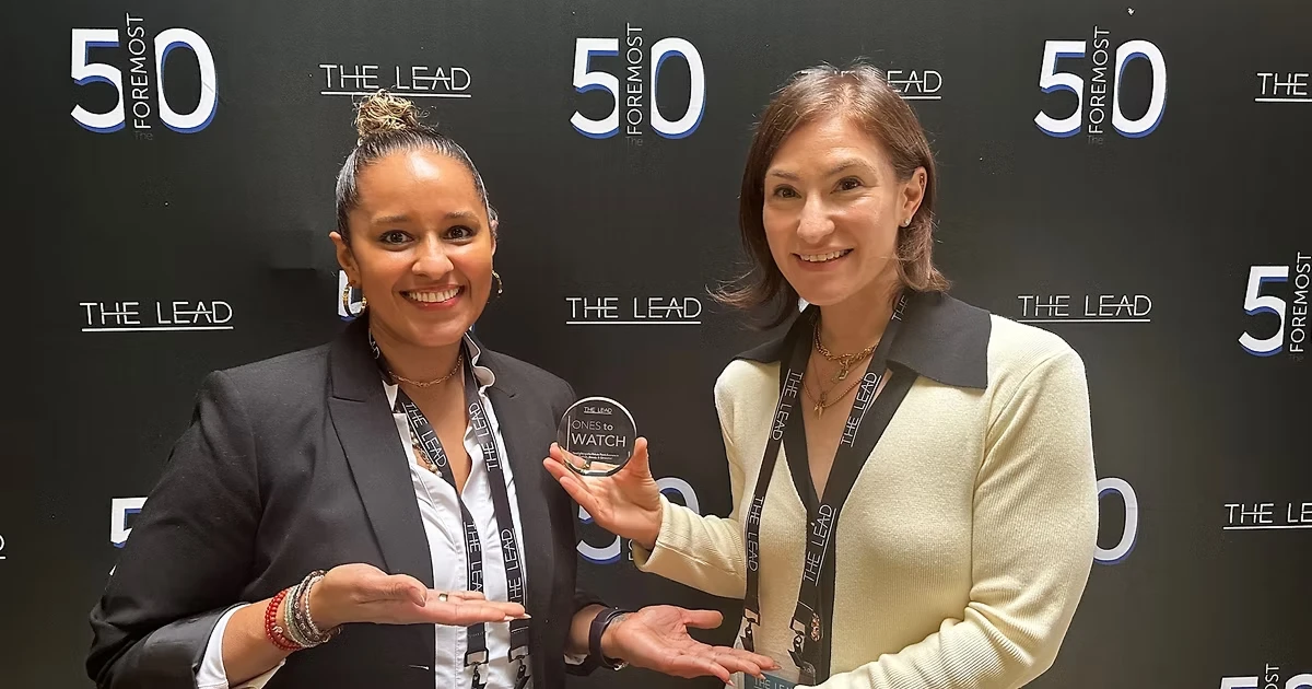 Lundyn Carter and her Laine London co-founder pose after receiving an award.