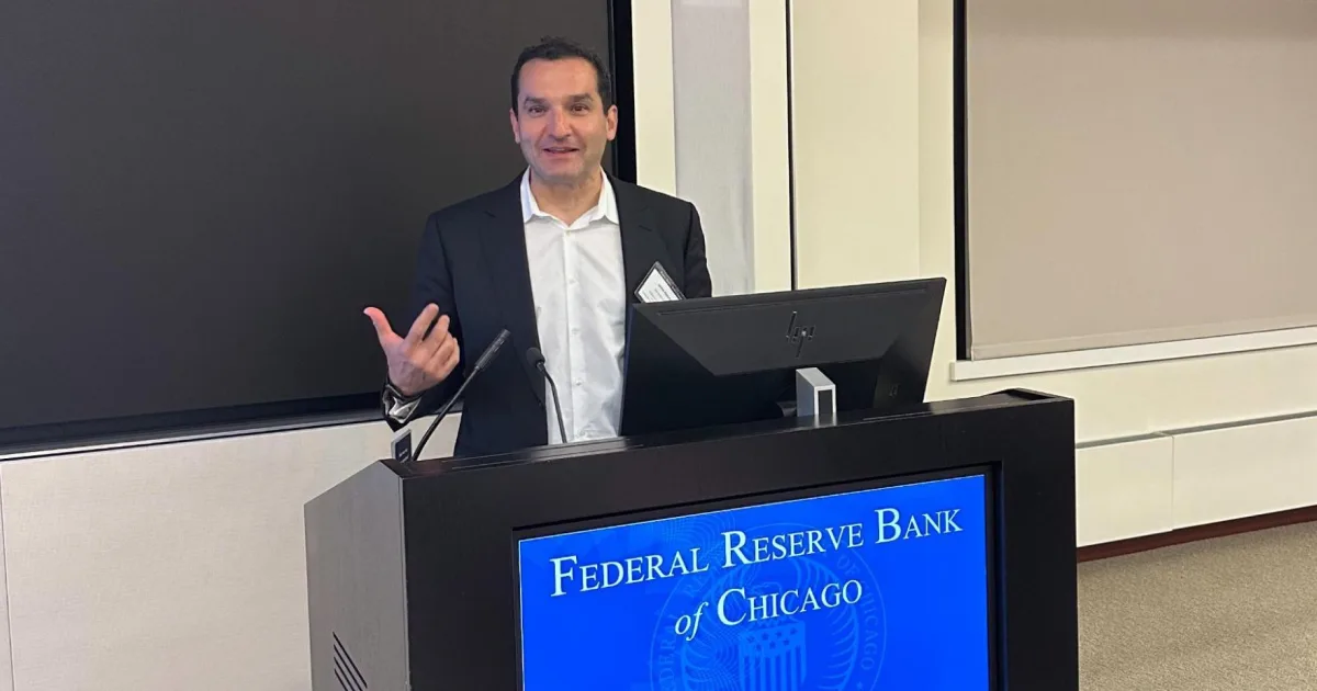 Jaime Aldama, president of Momentus Securities, speaks at a podium at the Federal Reserve Bank of Chicago.