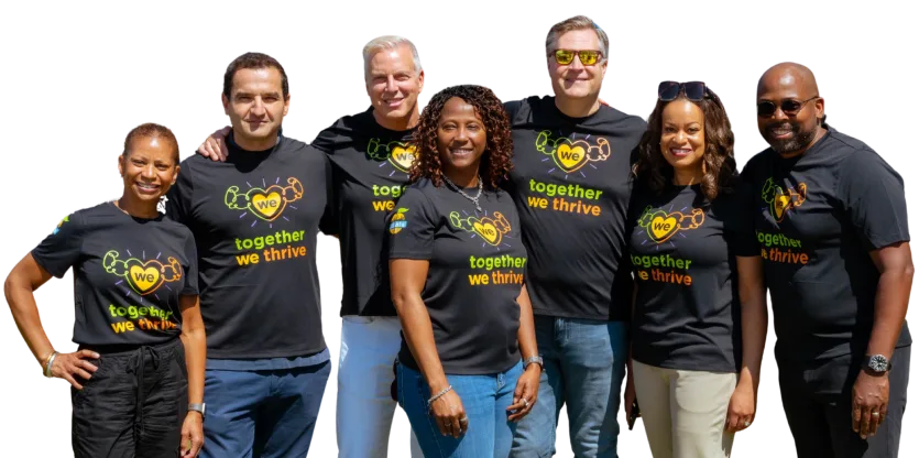 The Momentus Capital Executive Management team gathers together at the 2025 company all staff event, all wearing the same t-shirt and smiling (transparent background).